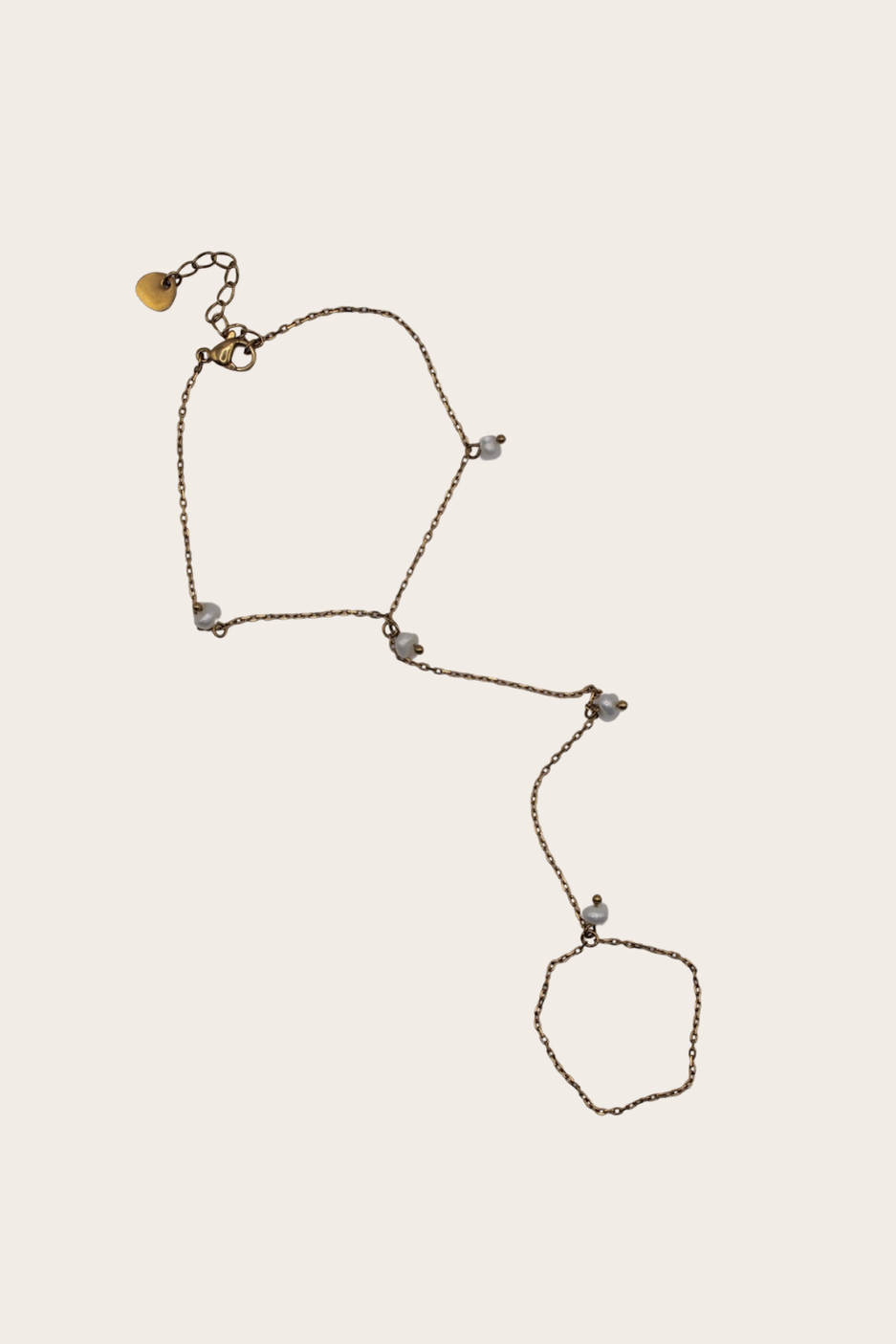 Dainty Pearls Hand Chain featuring a bracelet-to-ring chain with delicate pearl-style accents
