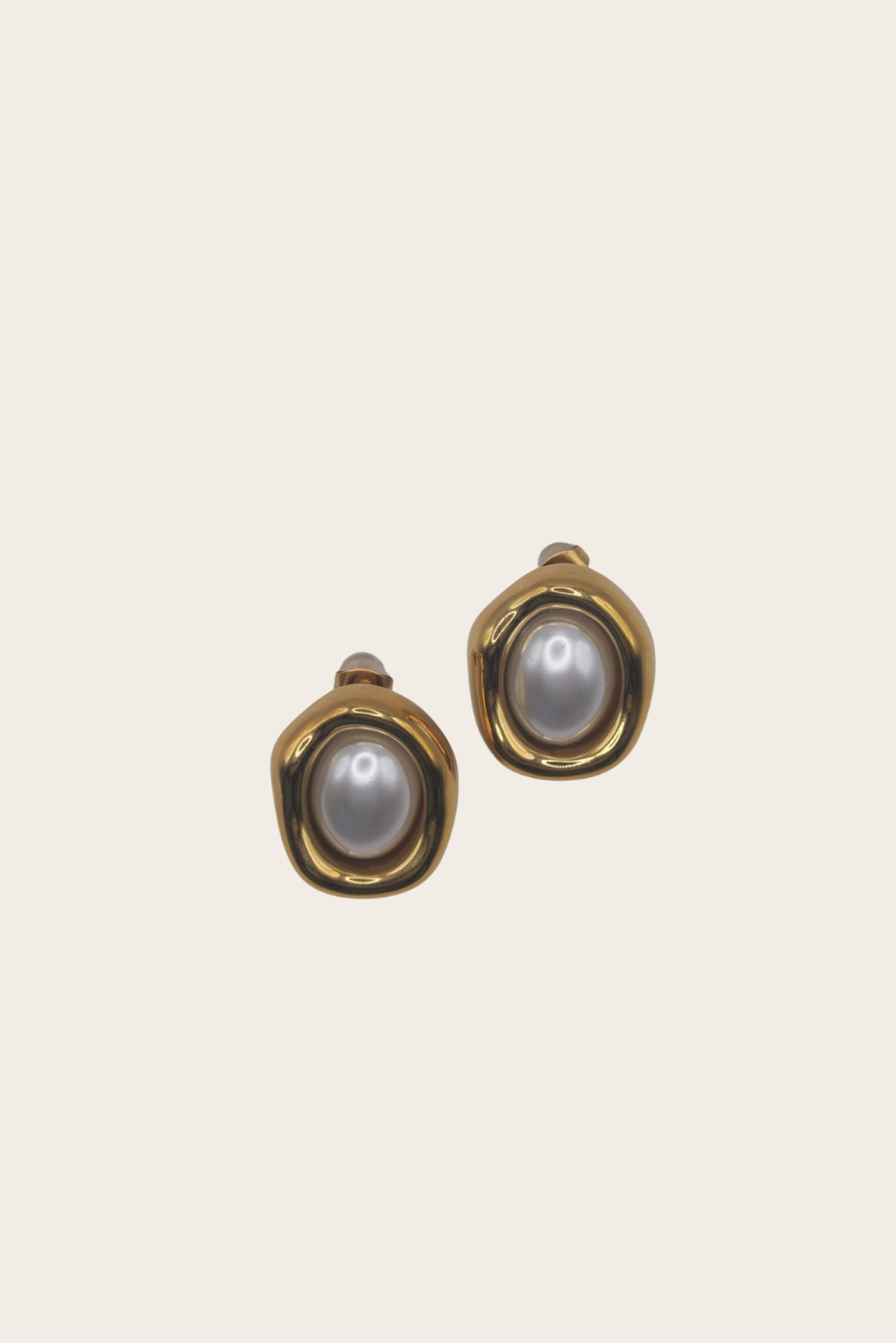 Perla Earrings featuring rounded drop earrings with pearl-style centers