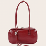 Burgundy East-West Bag, burgundy east-west bag featuring an elongated east-west silhouette with an included bag charm