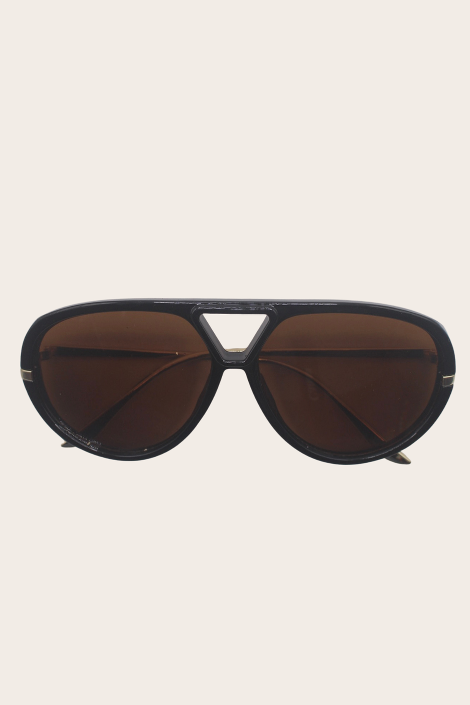 Salomé Sunglasses featuring a dark rounded frame with brown lenses