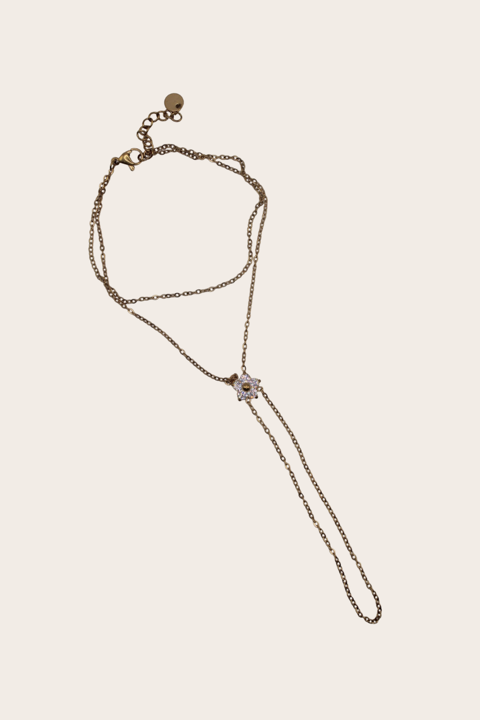 Diamond Flower Hand Chain featuring a bracelet-to-ring chain with a flower-inspired centerpiece