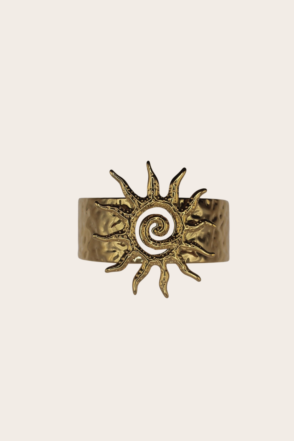 Hammered Sun Cuff featuring a wide cuff with a hammered sun motif