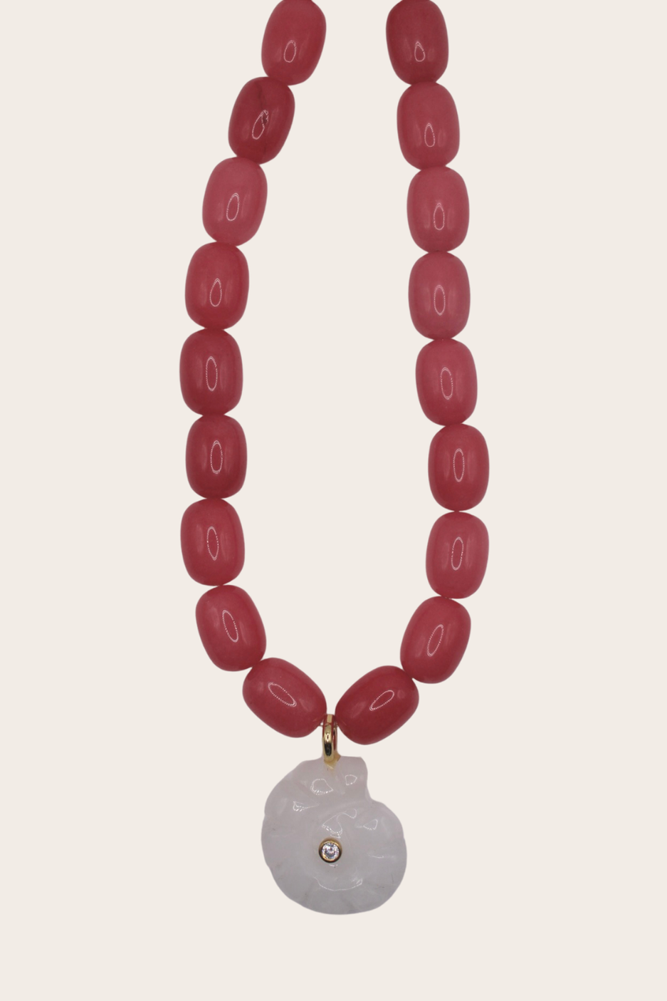 Coral Chain featuring chunky red beads and a pale round pendant