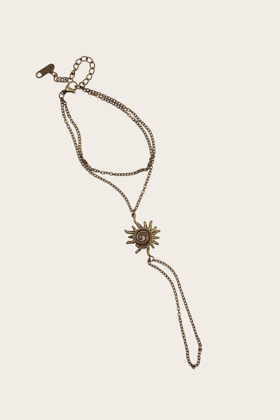 Retro Sun Hand Chain featuring a bracelet-to-ring chain with a sculptural sun centerpiece