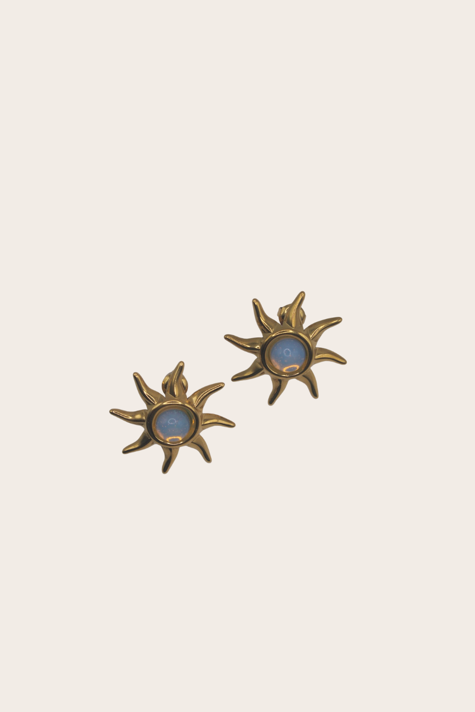 Opal Sun Earrings featuring sunburst studs with blue center accents