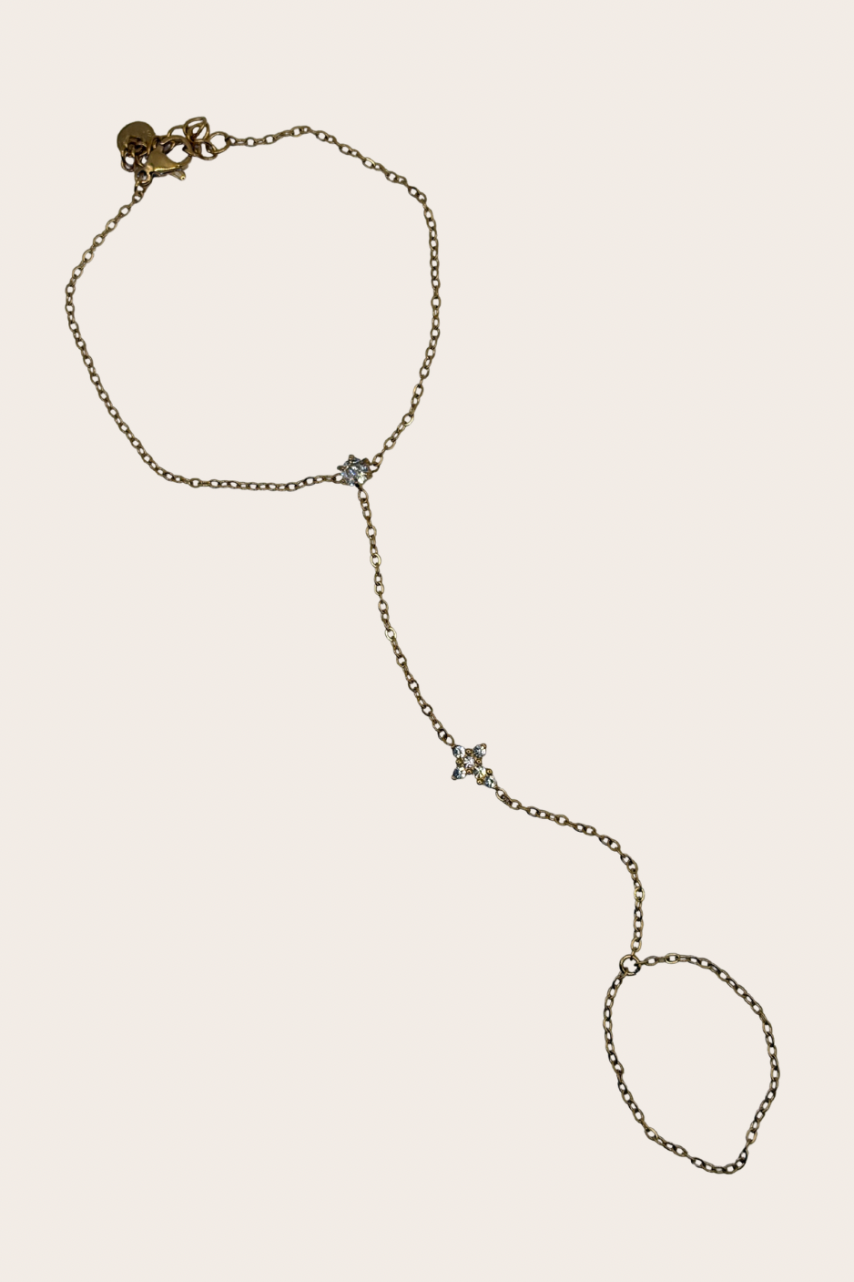 Dainty stainless steel hand chain with sparkling cross detail
