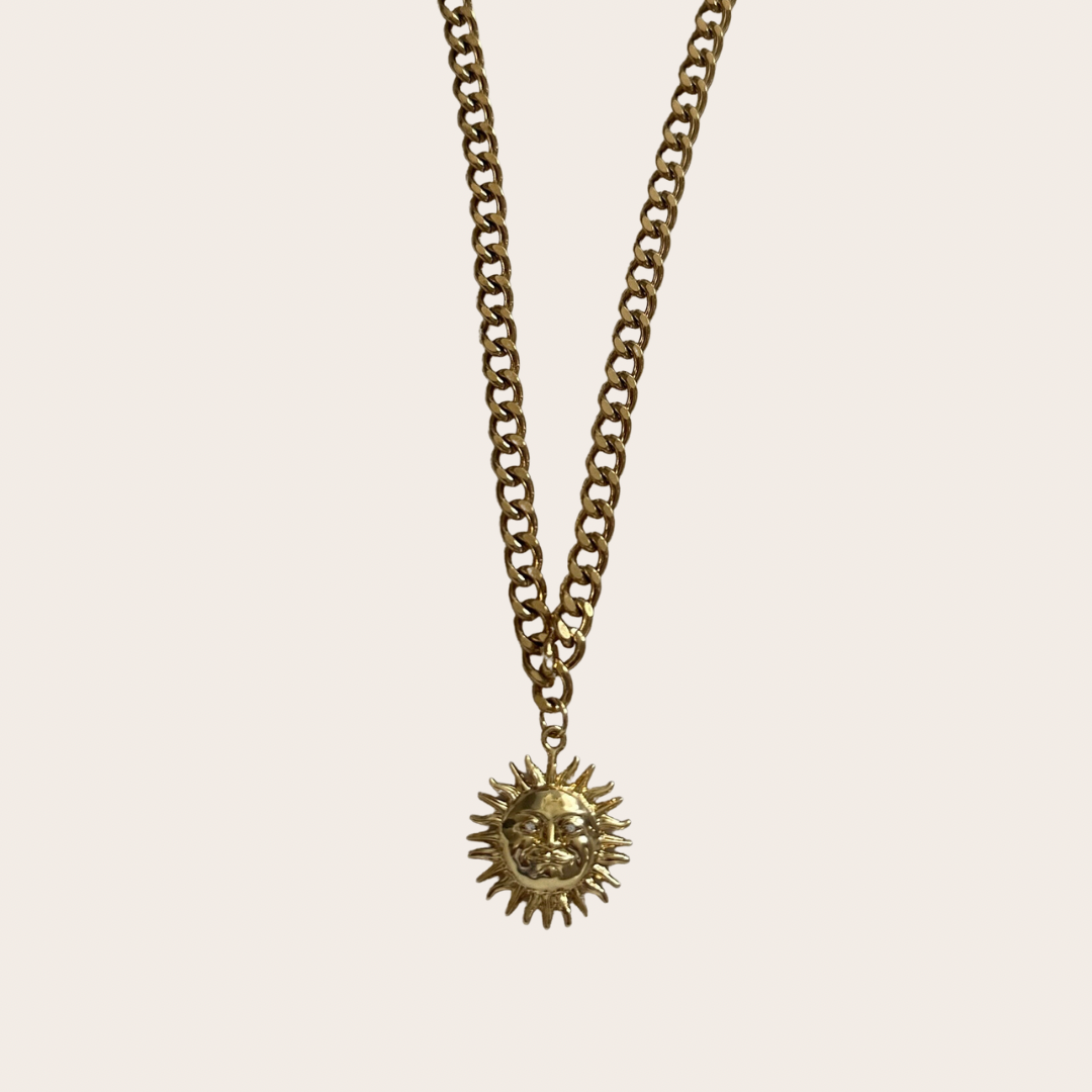 Gold stainless steel Soleil necklace with link chain and sun pendant.